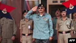 FILE - Then-Director General of Pakistani Rangers (Sindh) Karachi, Major General Rizwan Akhtar (C) salutes during a guard of honor prior to a meeting at India's Border Security Force (BSF) headquarters in New Delhi, July 2, 2012.