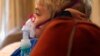 In this Tuesday, Oct. 15, 2013 photo, Carter Howard sits and watches a cartoon during his asthma treatment at his home in Northbrook, Ill.