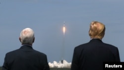 美国总统特朗普和副总统彭斯30日观看“猎鹰9”号(Falcon 9)火箭从佛罗里达州卡纳维拉尔角的肯尼迪宇航中心将两名美国宇航员送入太空。
