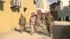 FILE - Marine Gen. Frank McKenzie (center) makes an unannounced visit in Kabul, Afghanistan, Jan. 31, 2020.