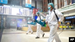 工作人员在北京火车站喷洒消毒剂。(2020年6月18日)
