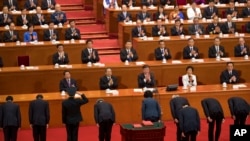 新任命的中国官员在全国人大会议宣誓就职后向中国国家主席习近平和其他主要领导人鞠躬。(2018年3月19日)