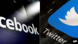 FILE - This combination of photos shows logos for social media platforms Facebook and Twitter.