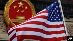 Tư liệu - Quốc kỳ Mỹ tung bay trước Quốc huy của Trung quốc. Ảnh chụp ngày 9/11/ 2017. (AP Photo/Andy Wong, File)