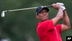 Tiger Woods watches his shot from the third tee during the final round of the Wyndham Championship golf tournament at Sedgefield Country Club in Greensboro, N.C., Sunday, Aug. 23, 2015.