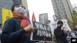 资料照:声援香港反送中运动以及新闻自由的台湾民众在台北的中国银行外举牌示威。(2021年12月30日)