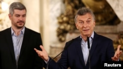FILE - Argentina's President Mauricio Macri speaks next to Cabinet Chief Marcos Pena during a news conference at the Casa Rosada Presidential Palace in Buenos Aires, Oct. 23, 2017.