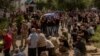Men carry coffins during the funeral of six Ukrainian servicemen, who were killed since Ukraine launched its offensive at the Russian border region of Kursk, in Sumy, northeastern Ukraine, Aug. 15, 2024.